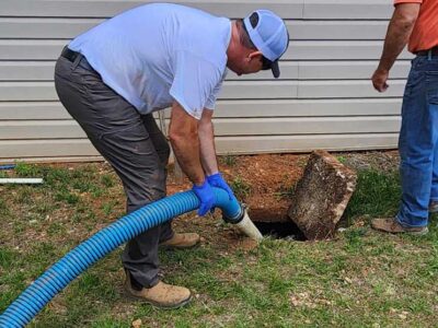 Man By Home Pumping Sewer