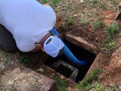 Man Looking In Sewer